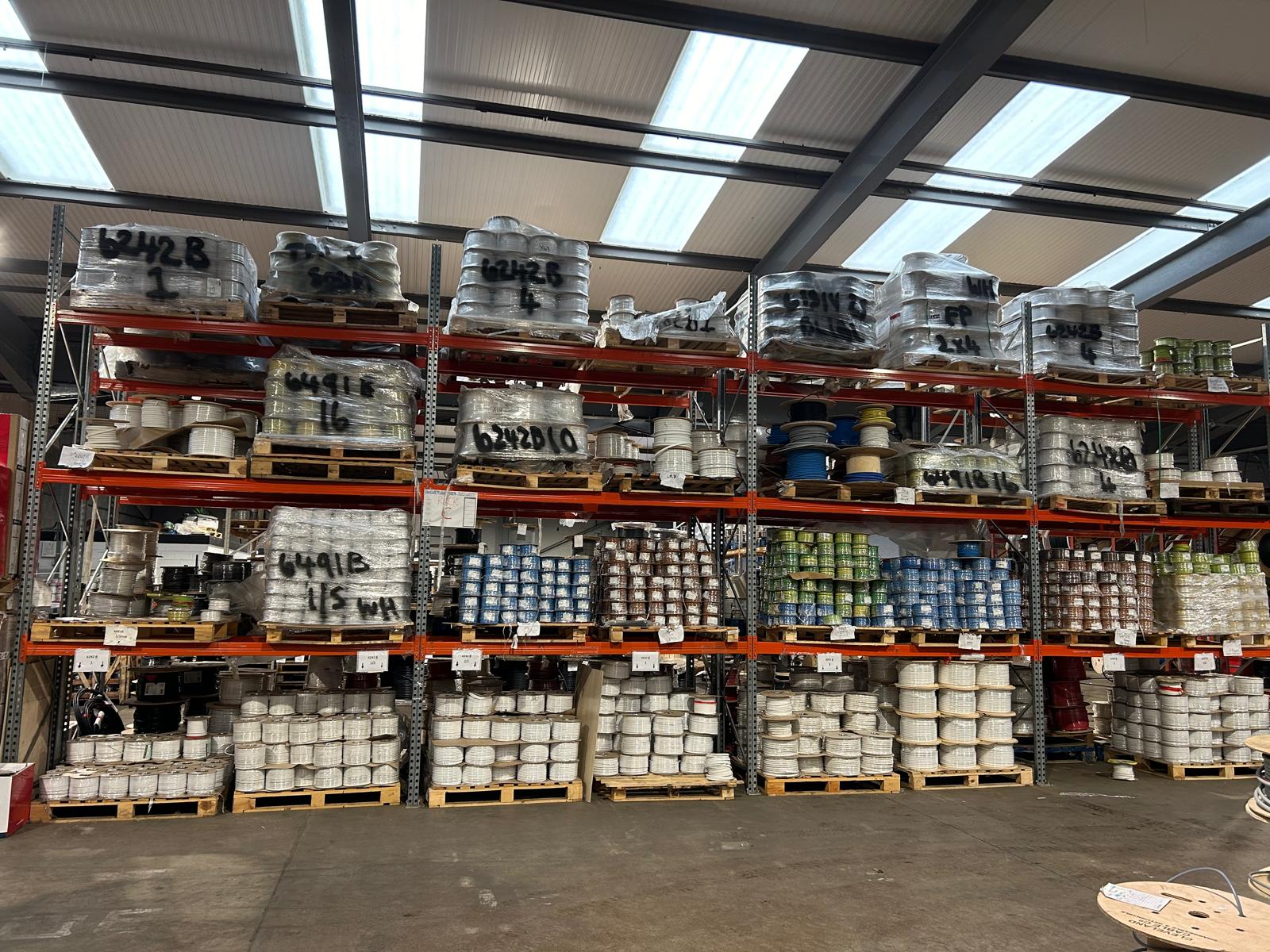 Clyde Cable depot — high racking stocked with reels of SWA, twin-and-earth and singles