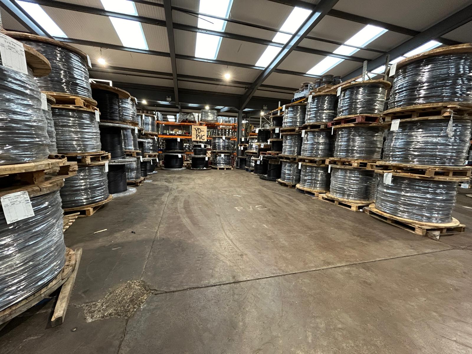 High-racking storage aisle stocked floor-to-ceiling at the Clyde Cable depot